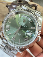 Stainless steel Rolex wristwatch with green dial and day/date display at 10