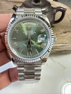 Stainless steel Rolex wristwatch with green dial, date window, jubilee bracelet
