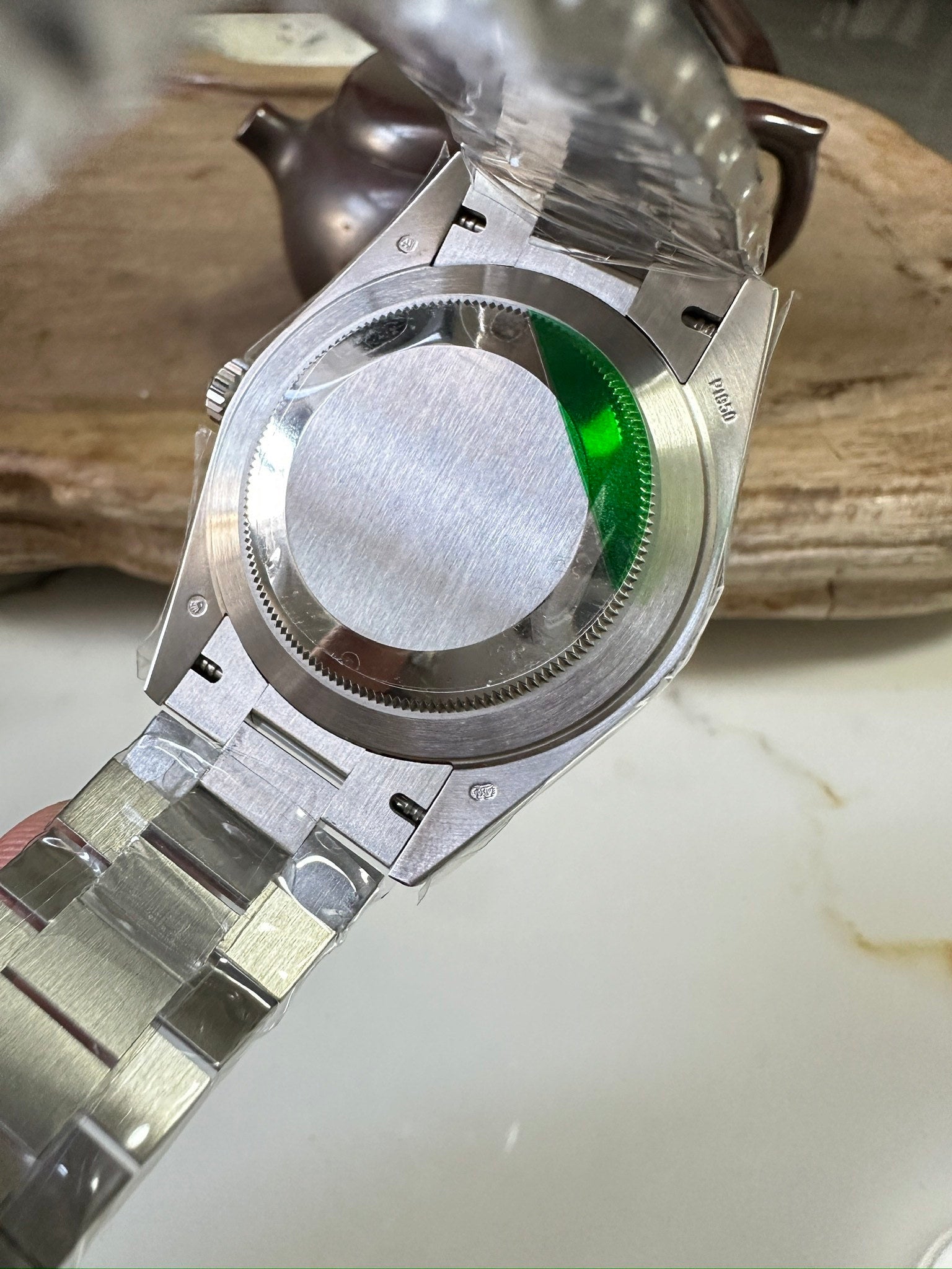 Stainless steel Rolex watch caseback with green gasket ring