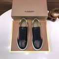 Burberry sneakers with black leather, lace-up front, beige check stripe and white sole.