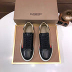 Burberry sneakers with black leather, lace-up front, beige check stripe and white sole.