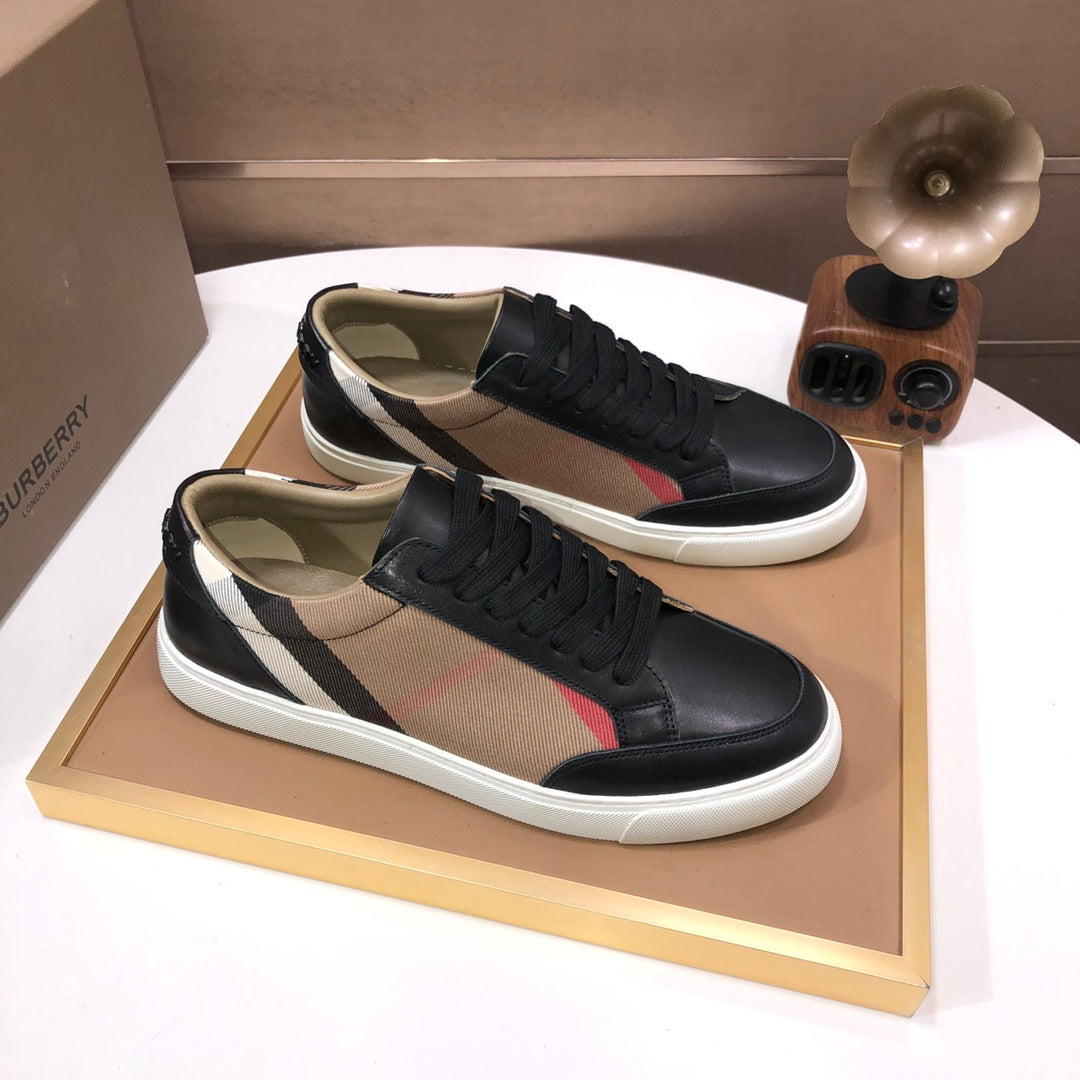 Burberry lace-up sneakers, black leather with beige panel and striped detail, white sole.