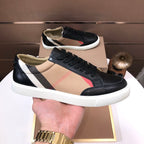 Burberry low-top sneakers, black leather with beige panel stripe and white sole.