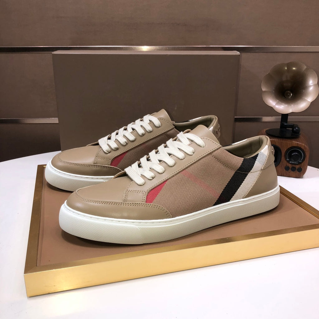 Beige low-top sneakers with white laces, black and white side stripe, red accent
