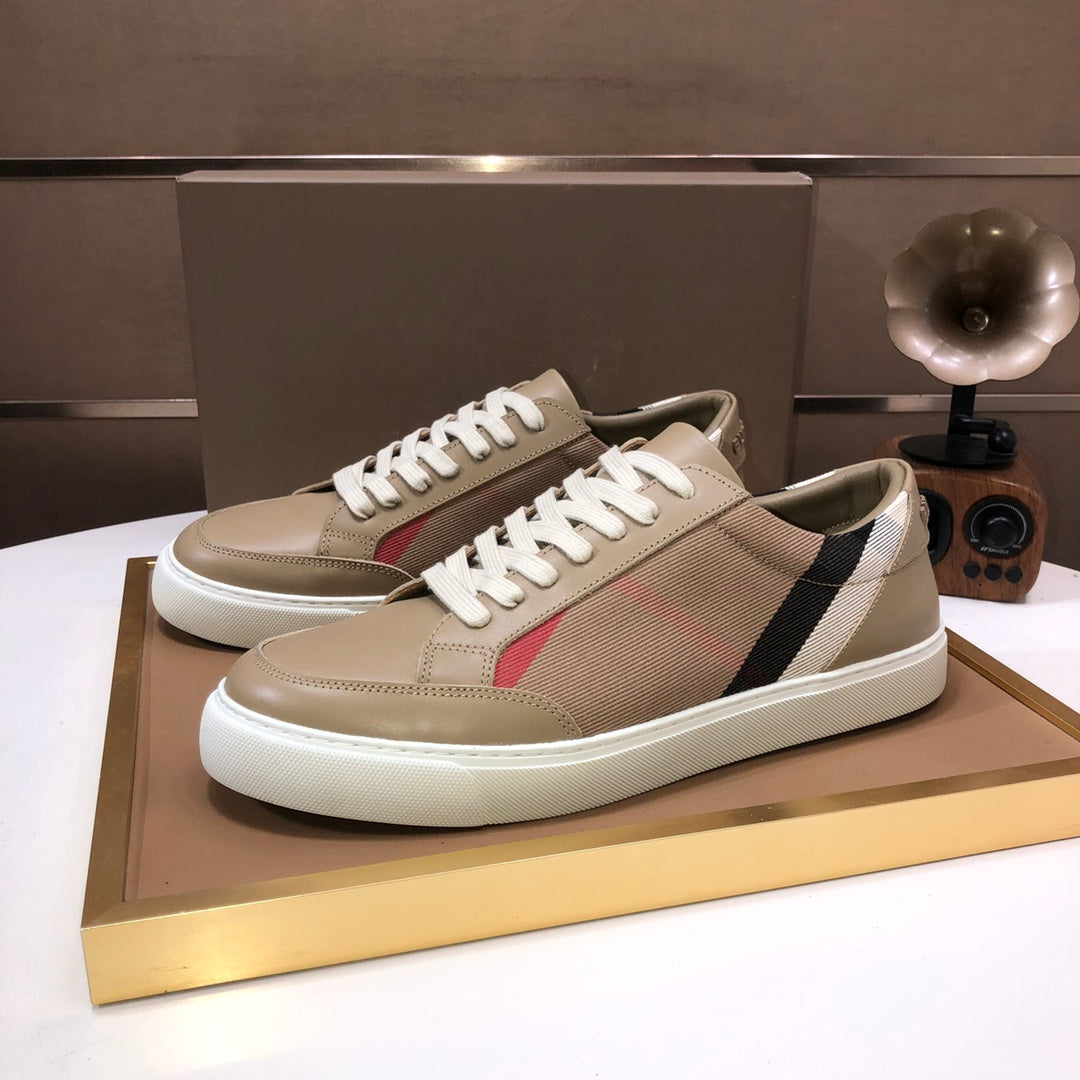 Beige low-top sneakers with white laces, black and white side stripe, red accent