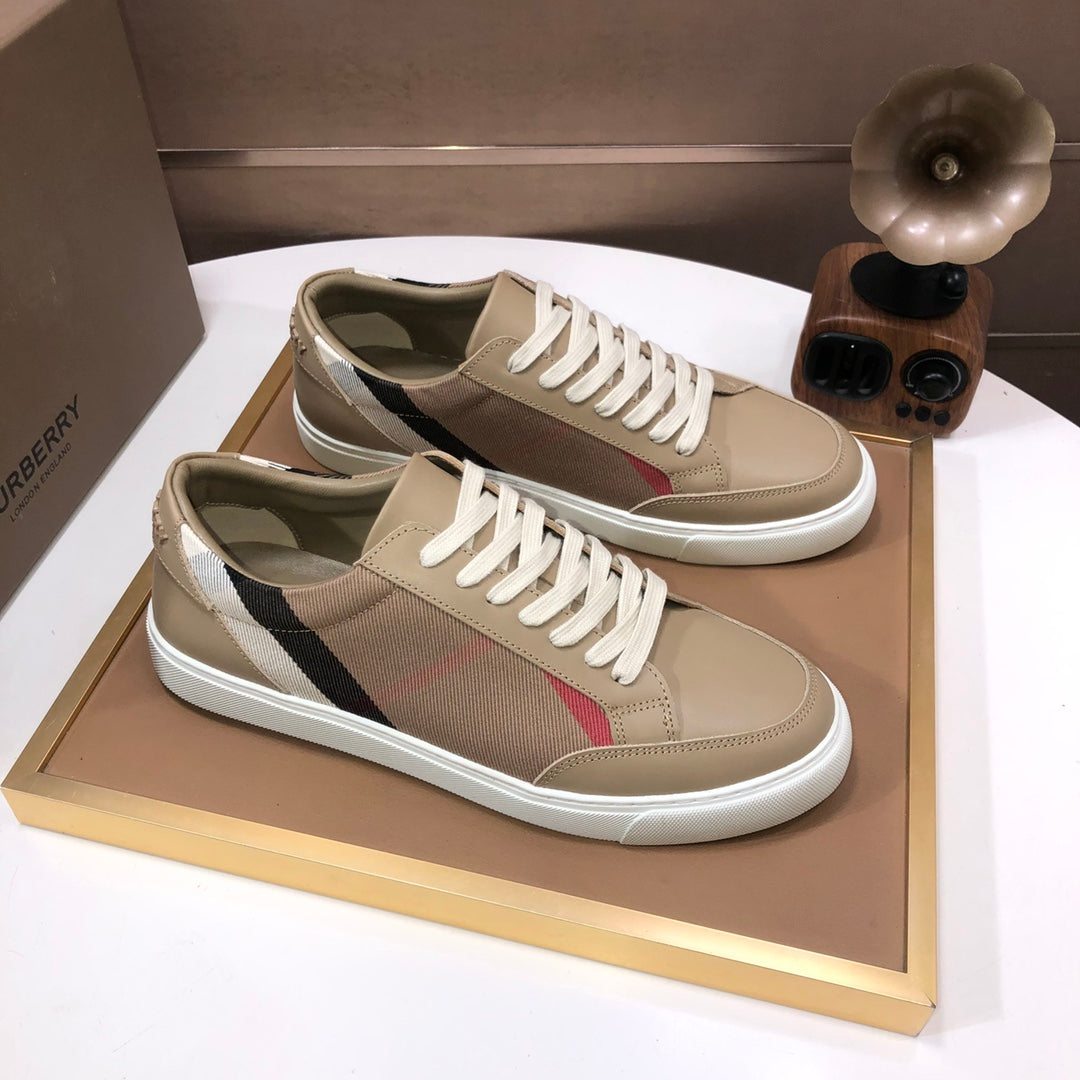 Beige low-top sneakers with plaid side stripe and white laces, pair on display tray