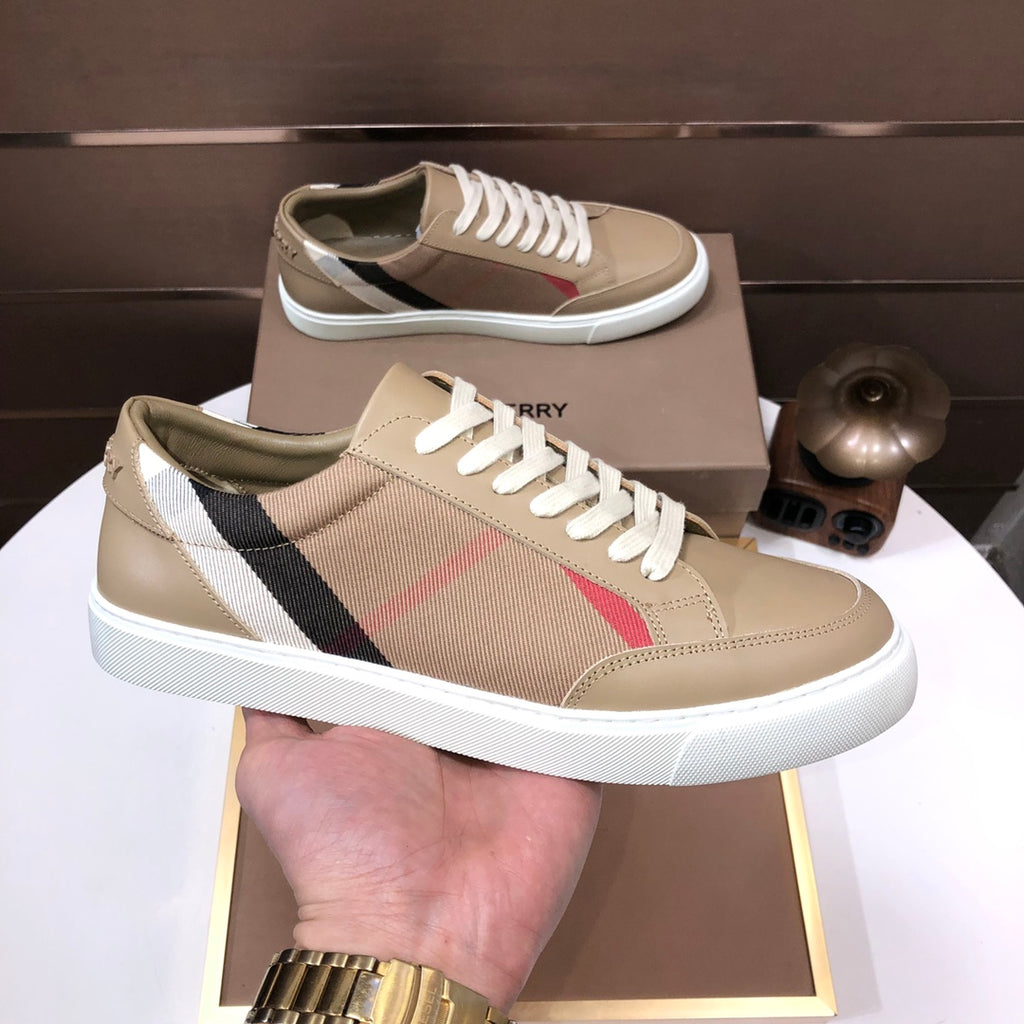 Beige low-top sneakers on tray with white laces and plaid side panel