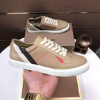Beige low-top sneakers on tray with white laces and plaid side panel