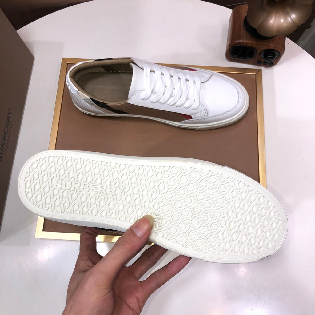 Burberry low-top sneaker outsole with white tread; white upper with tan check stripe