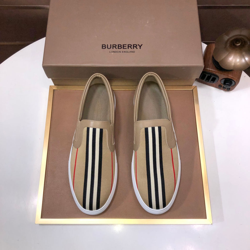Beige slip-on sneaker with black-and-white striped side and red accent stripe
