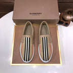 Beige slip-on sneaker with black-and-white striped side and red accent stripe