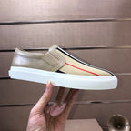 Beige slip-on sneaker side profile with striped band and red stripe, white sole