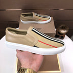 Beige slip-on sneaker with stitched upper, striped band, red stripe, white sole