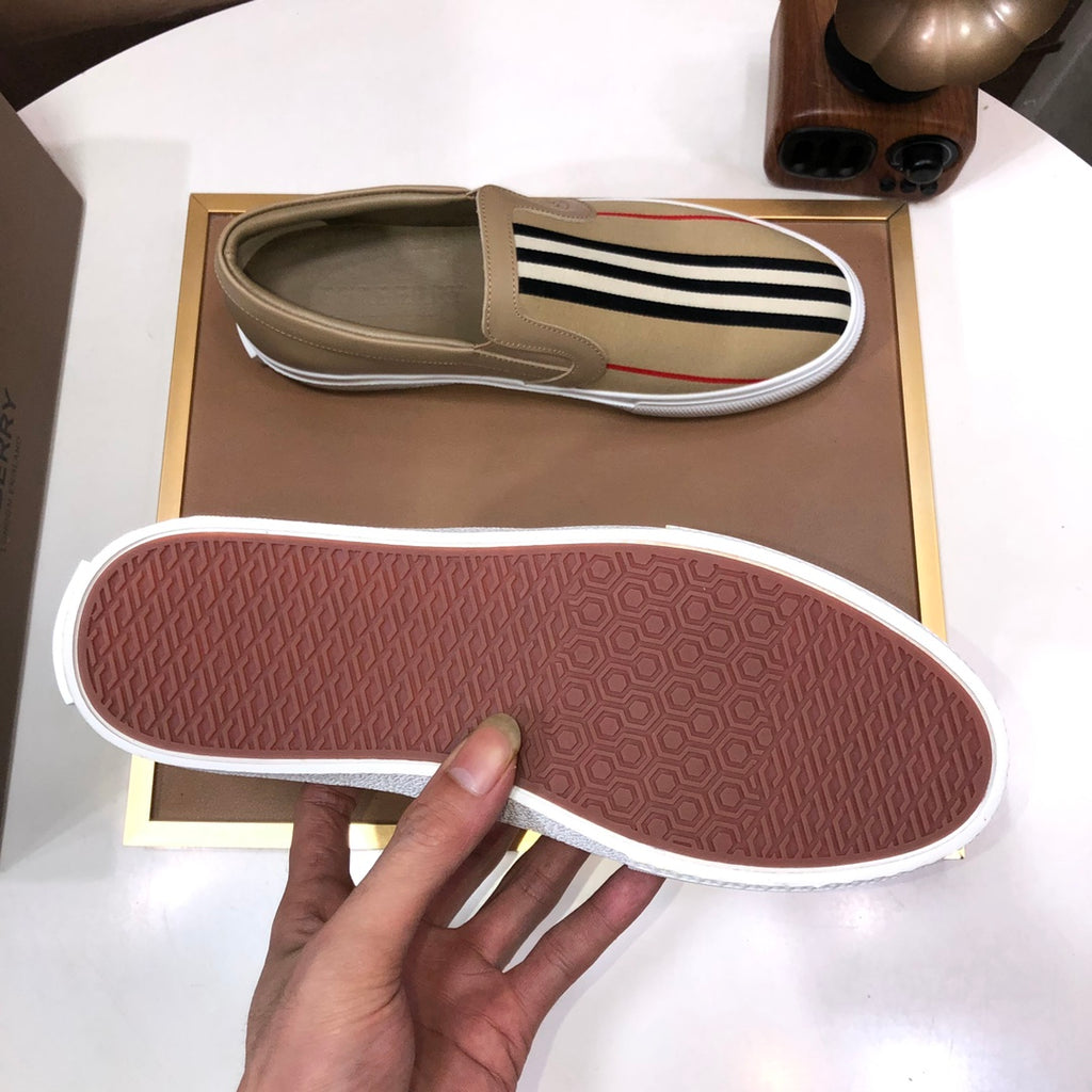 Beige slip-on sneaker outsole with textured tread and white edge