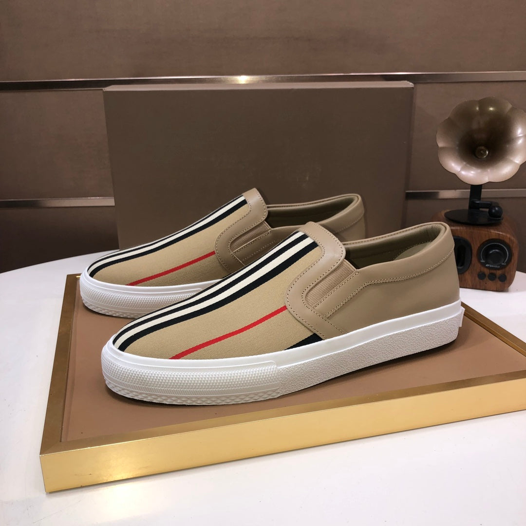 Beige slip-on sneaker with striped trim and red side stripe, white rubber sole