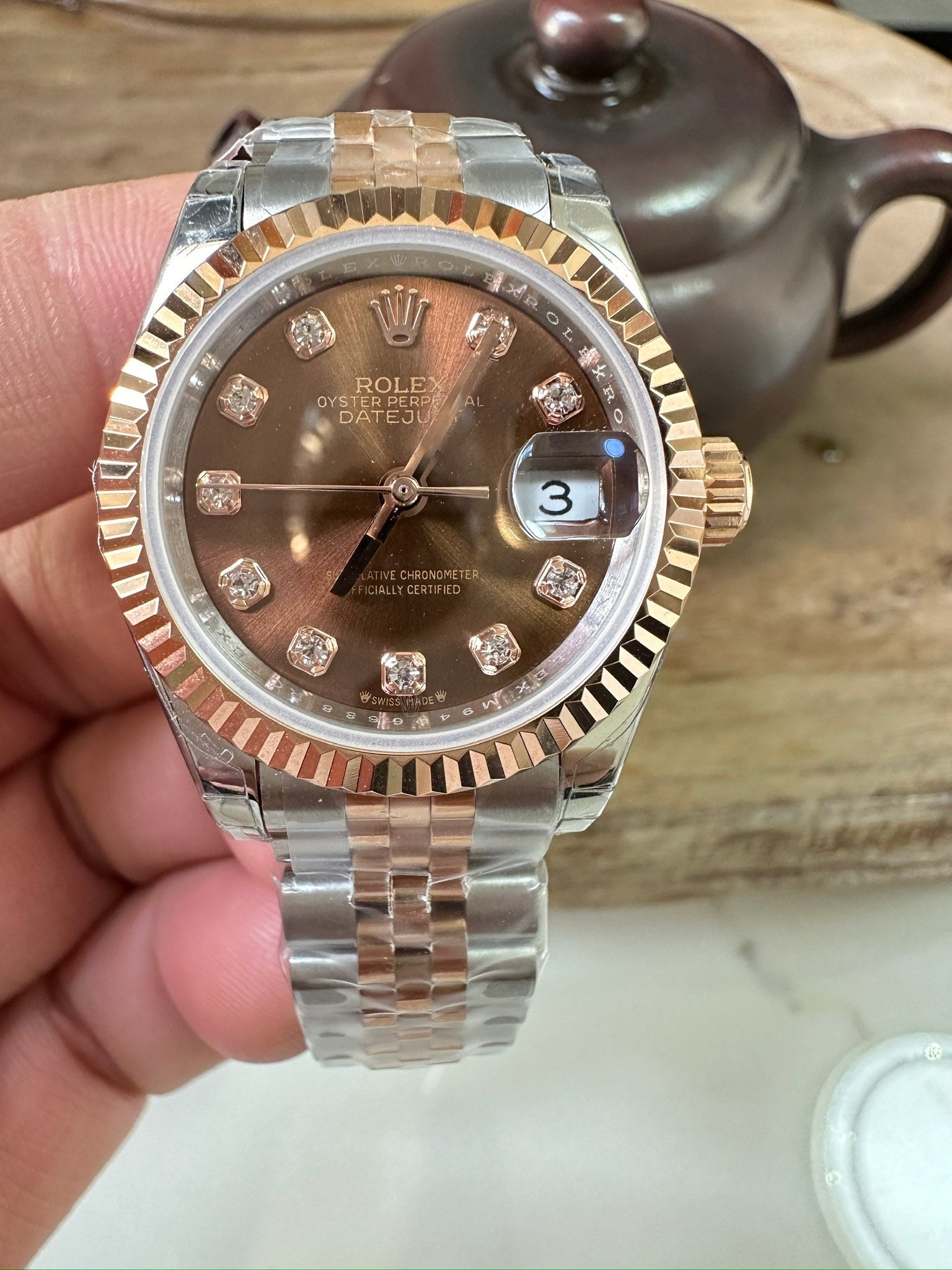 Rolex watch: diamond dial, two-tone steel/gold bracelet, date window at 3