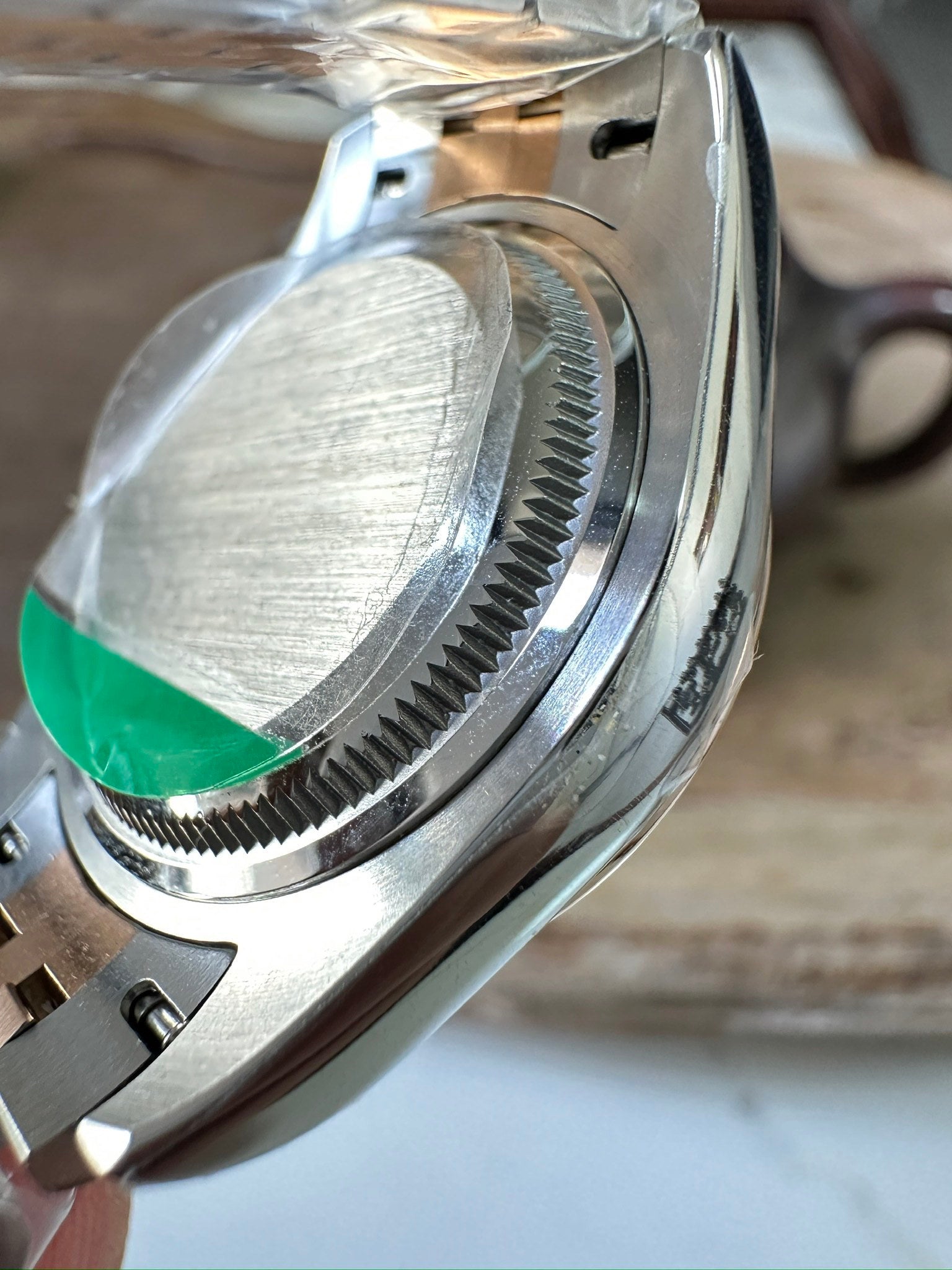 Rolex watch side view, two-tone steel case and bracelet with ridged bezel