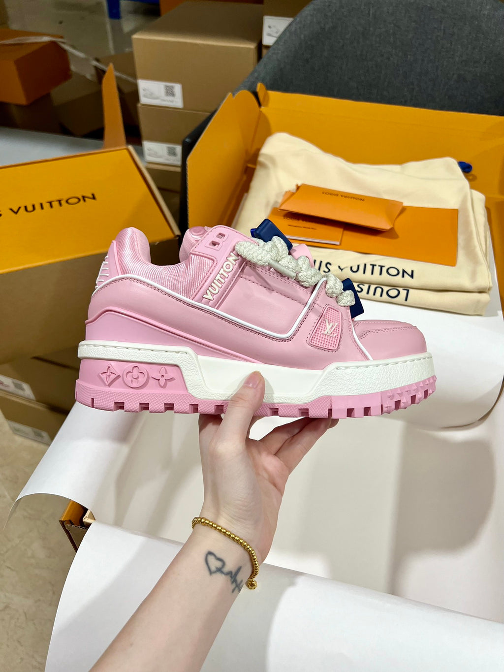Louis Vuitton pink lace-up trainer shoe with logo patches and chunky ridged sole