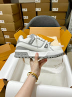 Louis Vuitton white lace-up trainer shoe with side logo patch and rugged gray sole