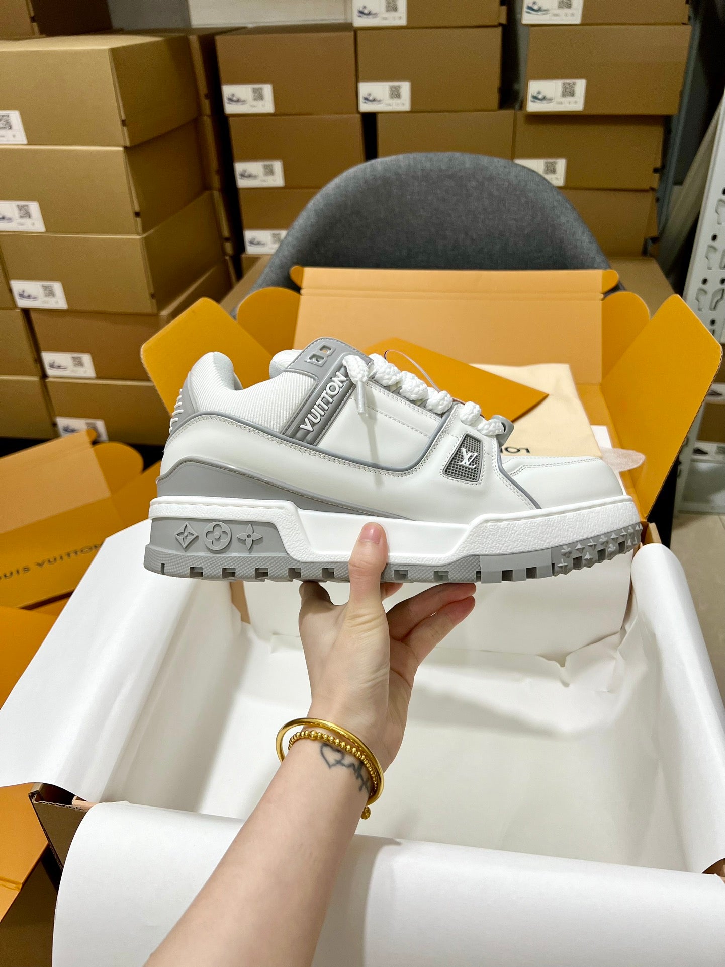 Louis Vuitton white lace-up trainer shoe with side logo patch and rugged gray sole