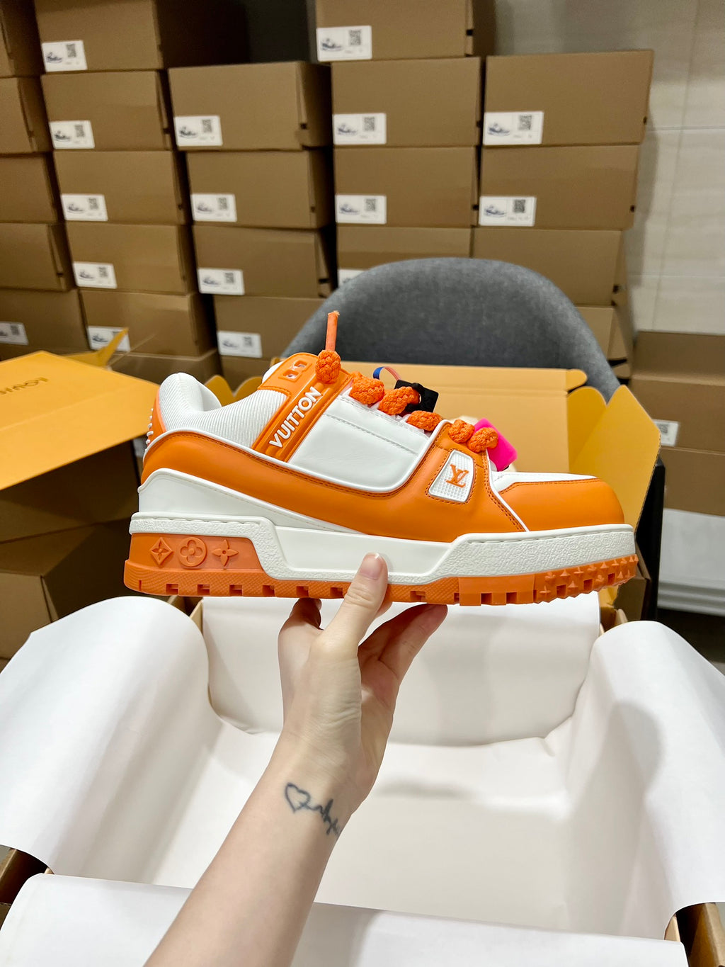 Orange and white trainer sneakers with monogram strap and chunky rugged sole