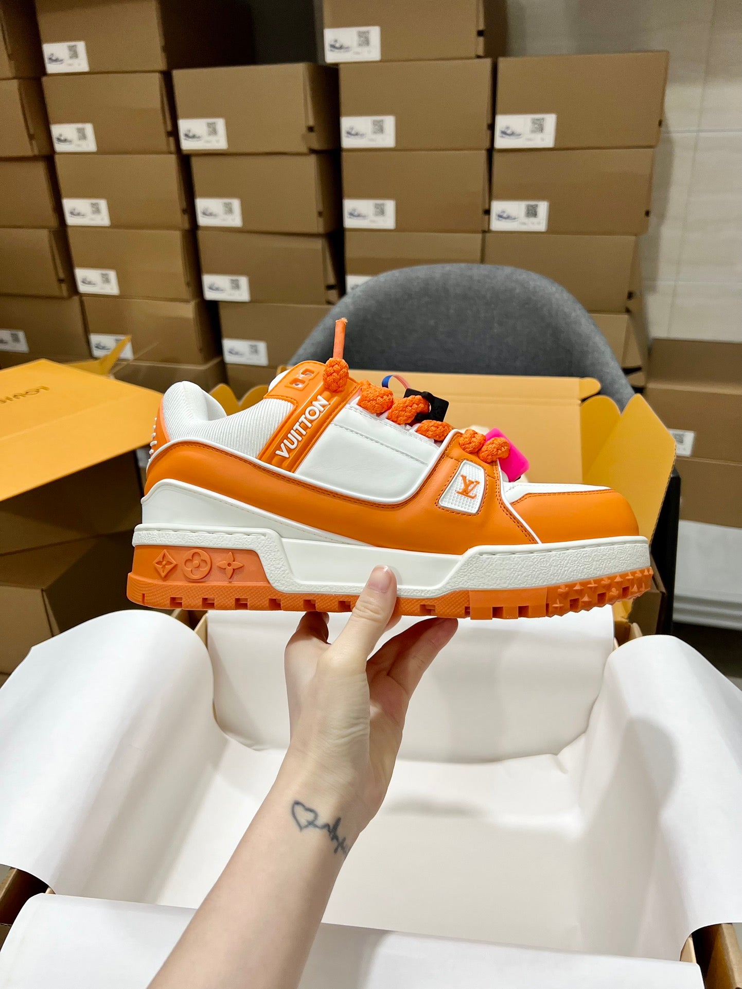 Orange and white trainer sneakers with monogram strap and chunky rugged sole