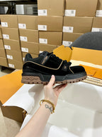 Louis Vuitton black lace-up trainer shoe with gold trim and chunky tread sole