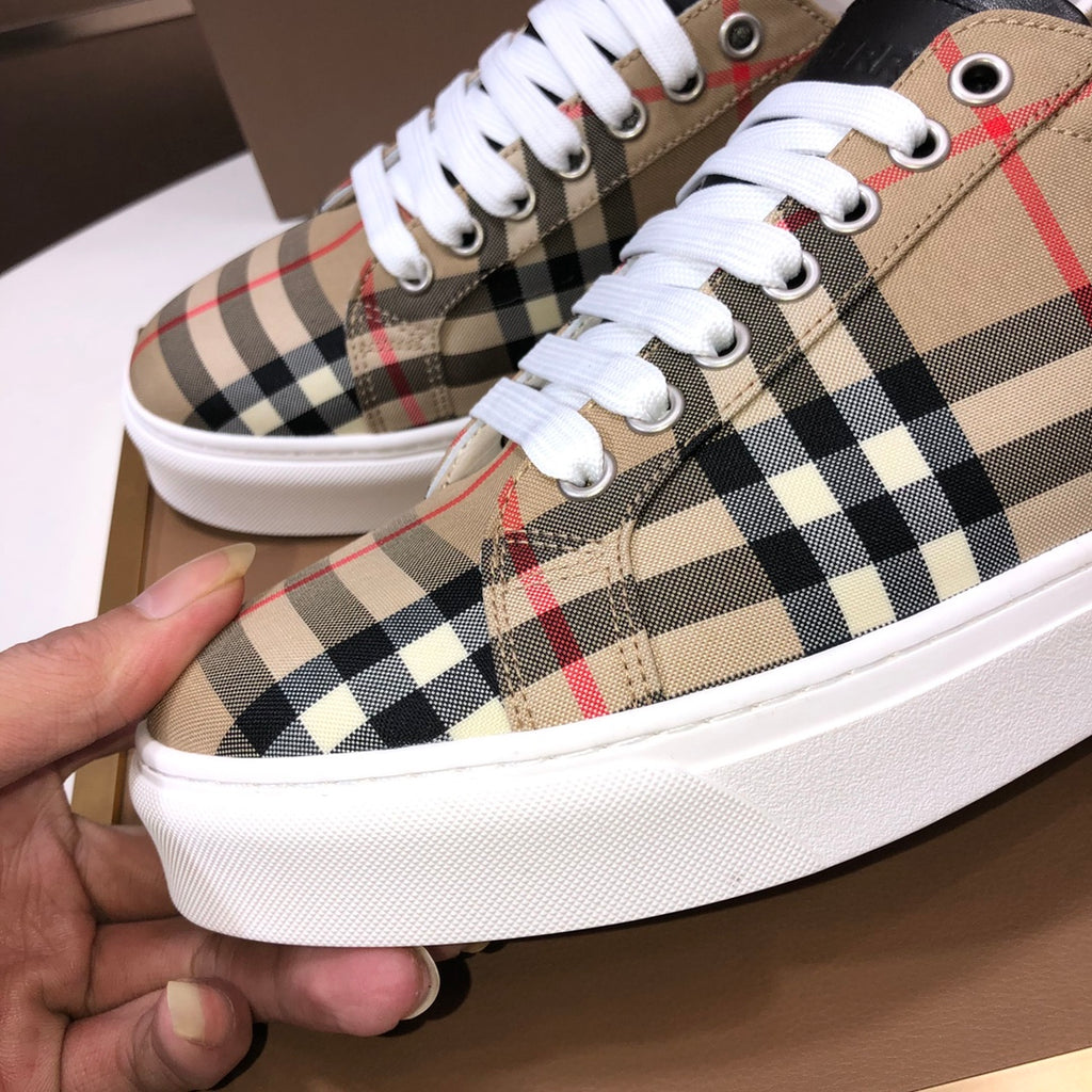 Burberry low-top sneakers close-up, beige check with white laces and metal eyelets