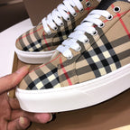 Burberry low-top sneakers close-up, beige check with white laces and metal eyelets