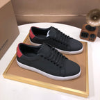 Burberry dark leather low-top sneakers with red heel stripe, lace-up