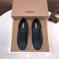 Burberry dark leather lace-up sneakers with red heel accent and white rubber sole