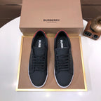 Burberry dark leather lace-up sneakers with red heel accent and white rubber sole
