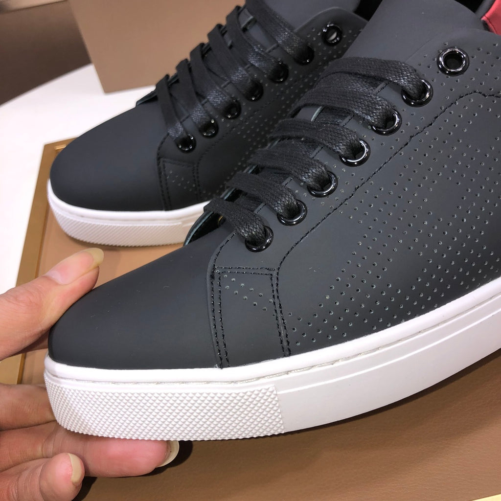 Burberry dark leather sneakers close-up: lace eyelets, textured upper, white sole
