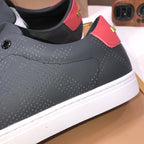 Burberry dark leather sneaker side, perforated pattern and red heel strap