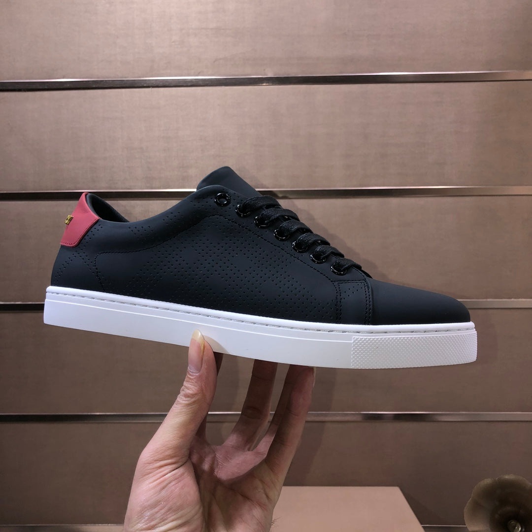Burberry dark leather sneakers held in hand, lace-up, white rubber sole