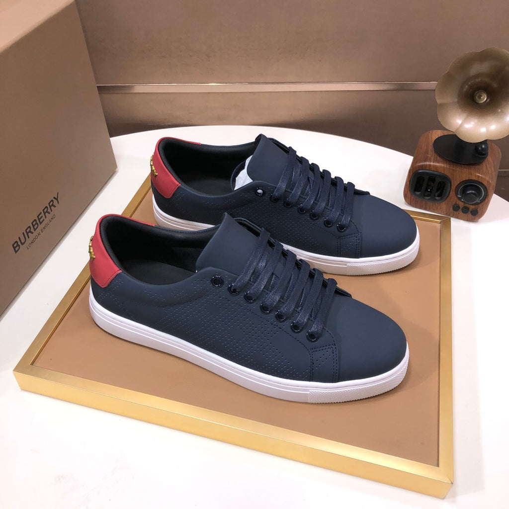 Burberry lace-up sneakers, dark navy leather with red heel trim and white midsole.