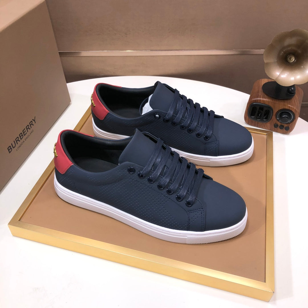 Burberry lace-up sneakers, dark navy leather with red heel trim and white midsole.