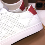 Burberry white sneakers with red strap detail and perforated upper