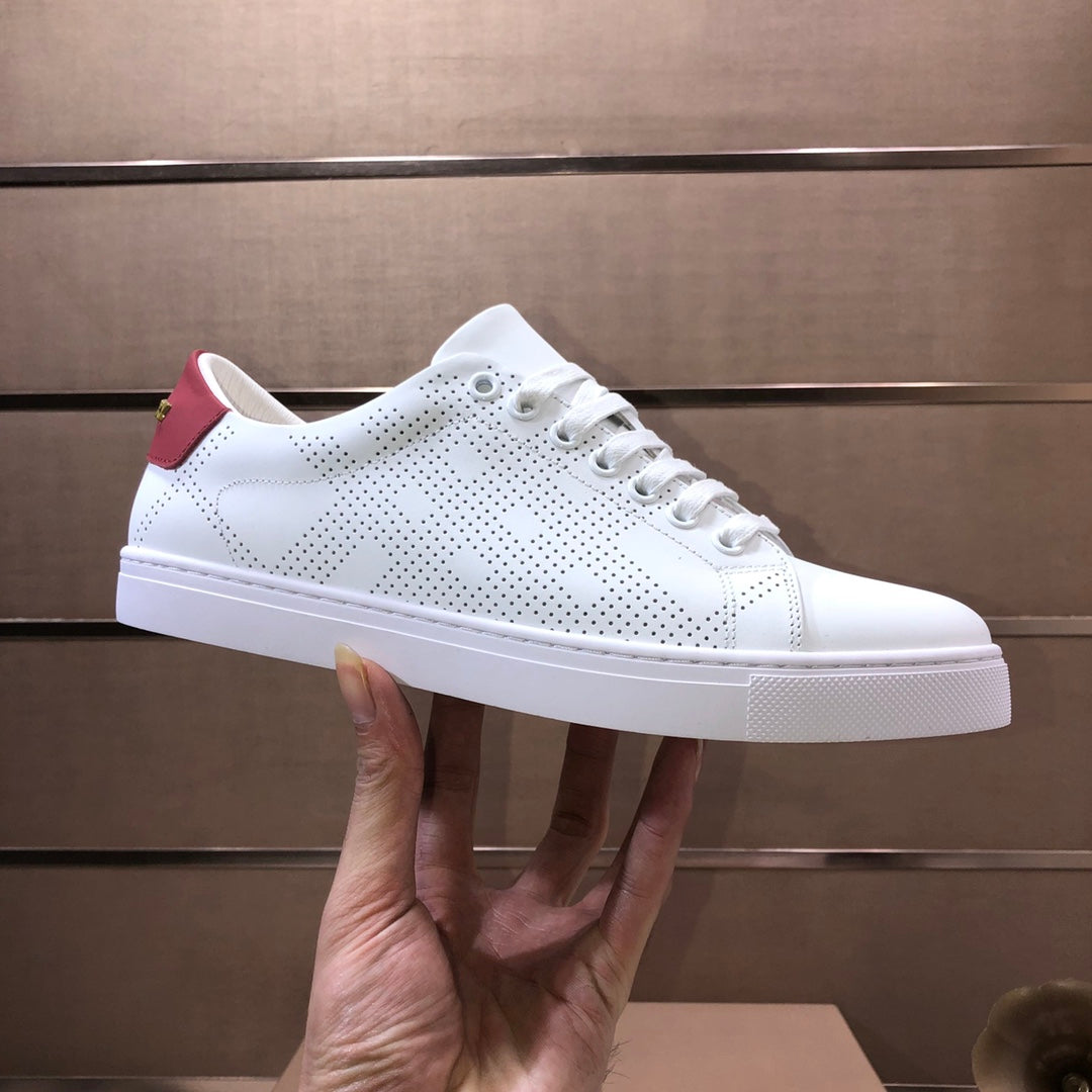Burberry white perforated sneakers with red collar accent, lace-up profile