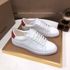 Burberry white lace-up sneakers with red heel panels and perforated upper