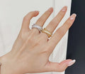 Pavé band rings in gold-tone and silver-tone on hand, three stacked bands