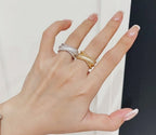 Pavé band rings in gold-tone and silver-tone on hand, three stacked bands