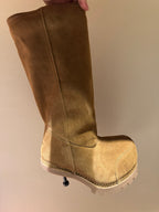 Tan suede knee-high boots with seam detailing and chunky white sole