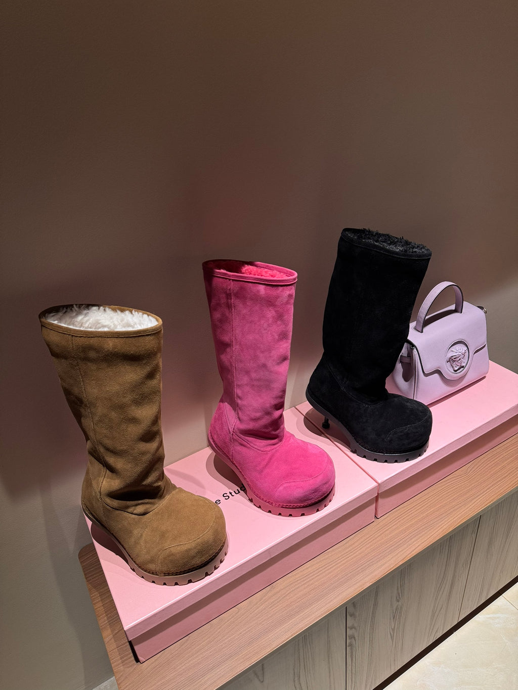 Knee-high suede boots in tan, pink, and black with shearling lining