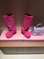 Pair of women's Balenciaga magenta suede boots, tall shaft and textured lug sole