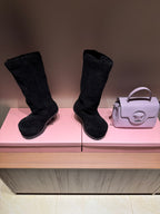 Pair of black suede boots with chunky tread soles