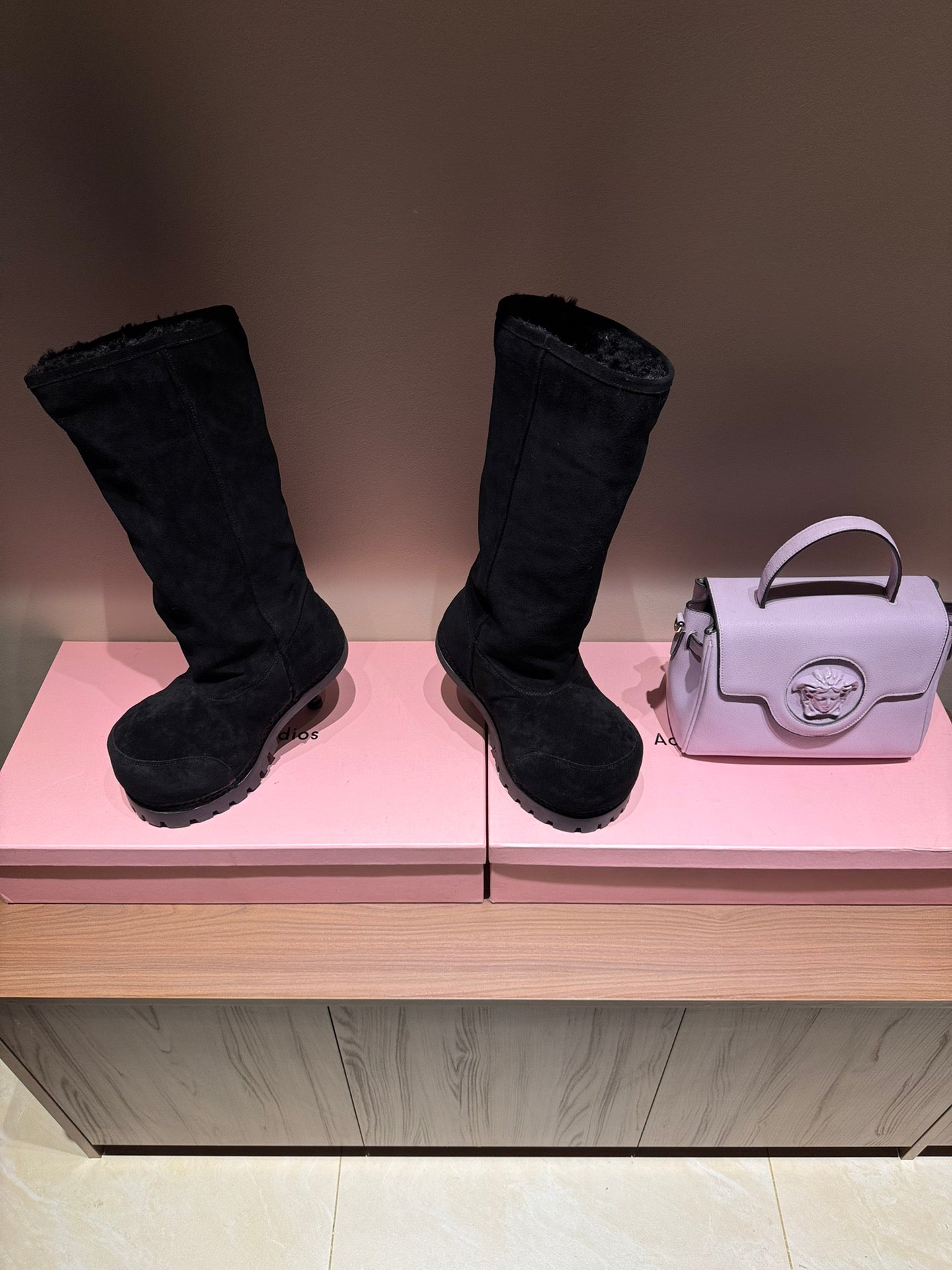 Pair of black suede boots with chunky tread soles