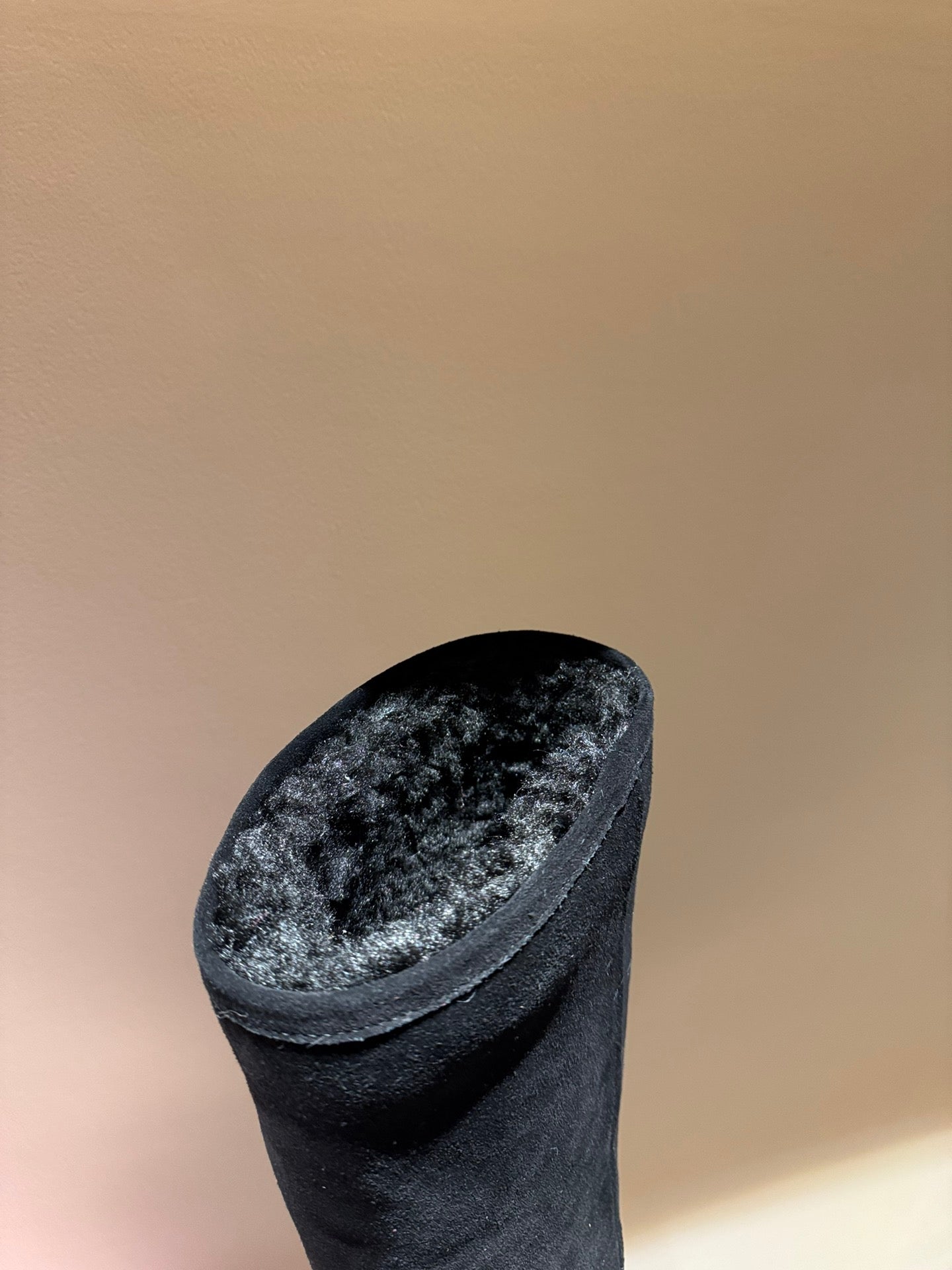 Black suede slip-on boot with rounded toe and short cuff