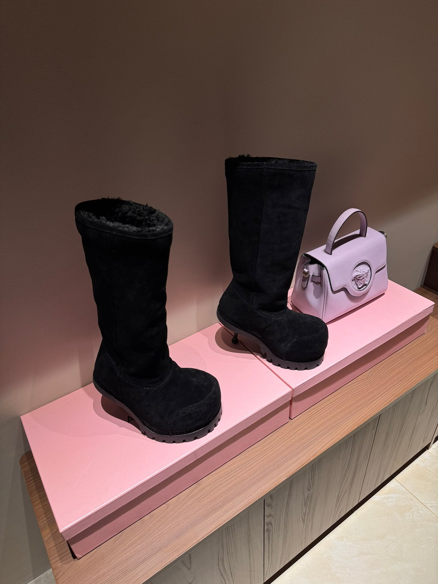 Black suede knee-high boots with chunky tread sole