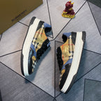 Burberry low-top sneakers shown from the side with plaid panels, gold emblem, white rubber sole